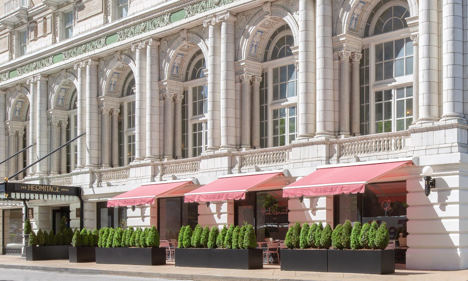 Exterior Shot of Pink Hermit with awnings.